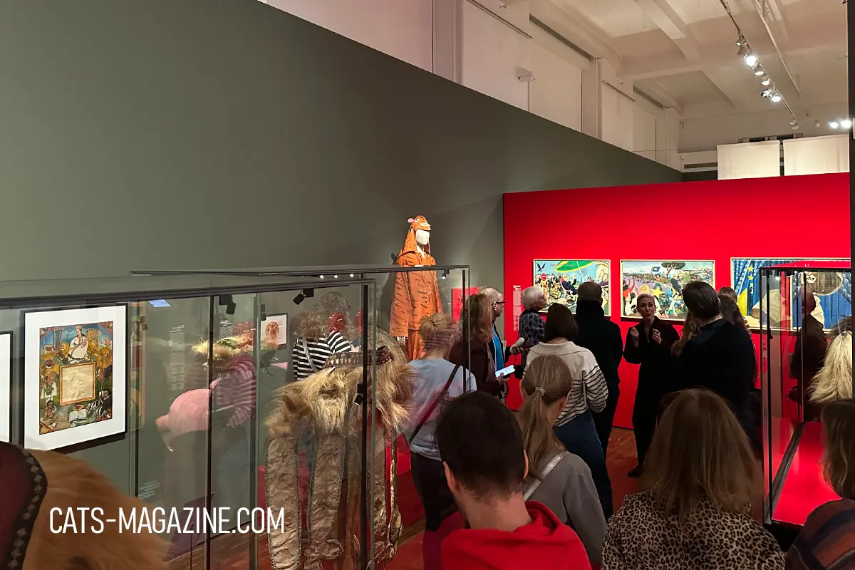 Visitors standing in front of tiger-themed exhibits and colorful artworks in the “Useful” section of the CATS! exhibition at MARKK Hamburg.