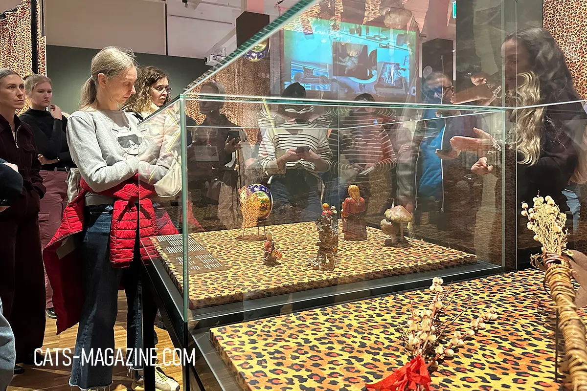 Cat-related objects placed on leopard-print displays—an immersive look at feline symbolism across continents.