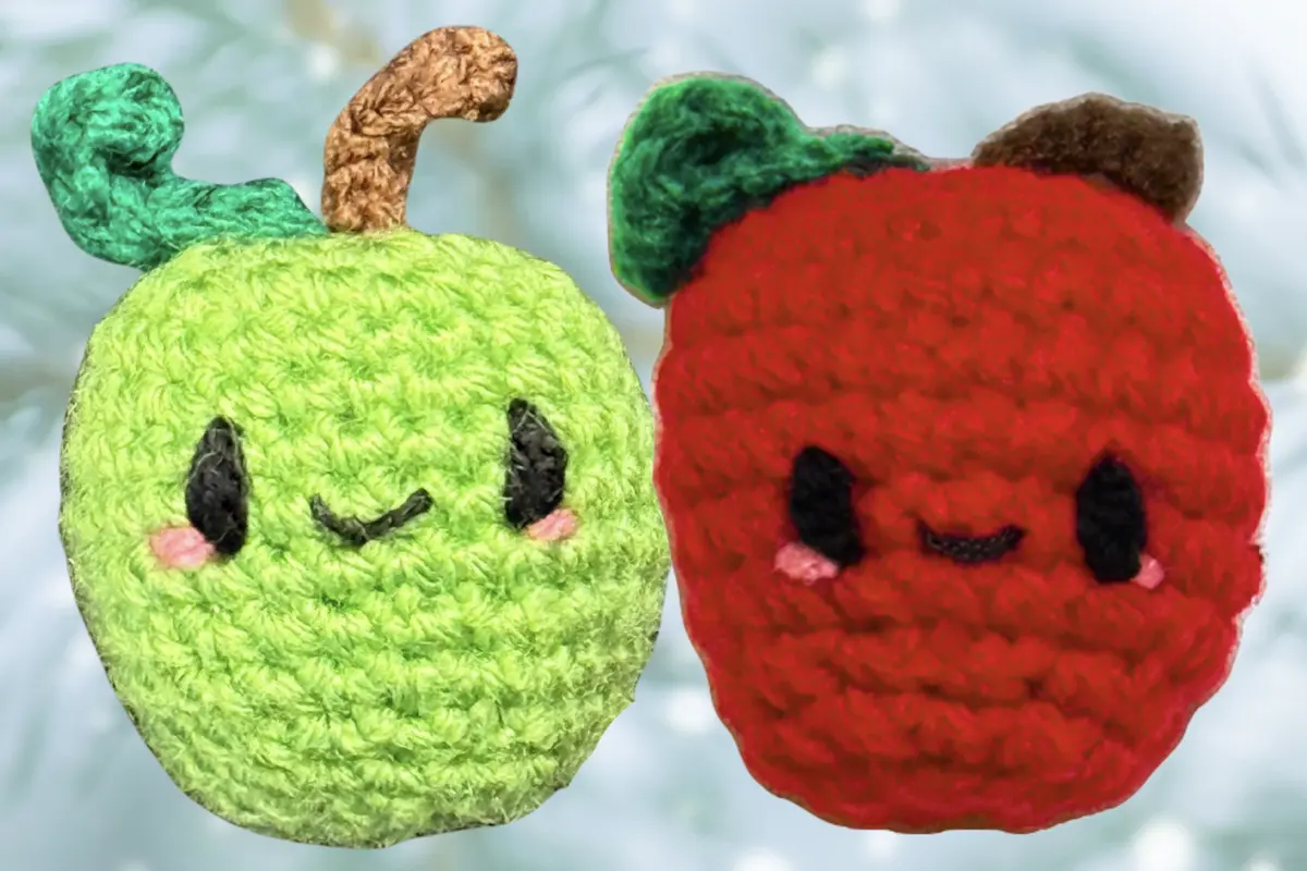 Crocheted green and red apple-shaped Chunkles, part of Minou Le-Mew’s winter cat toys collection.