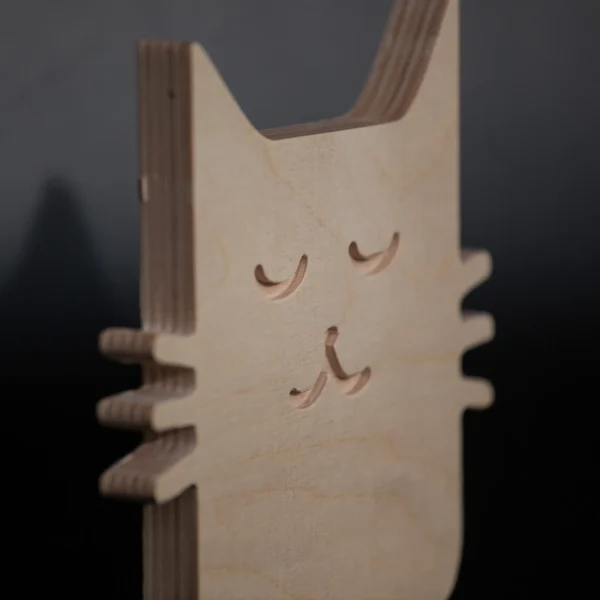 Plywood cat decor layered wood detail Side detail of handmade plywood cat showing layered construction
