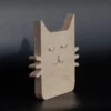 Minimalist wooden cat decor angled view Angled view of small minimalist plywood cat decor