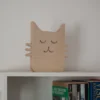 Small plywood cat decor on shelf Handmade wooden cat decor displayed on a shelf for scale