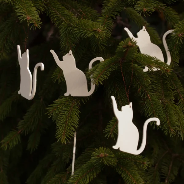 Zen Cat Wooden Ornaments – Set of 5 on Evergreen Branch Set of five minimalist wooden cat ornaments hanging on an evergreen tree branch