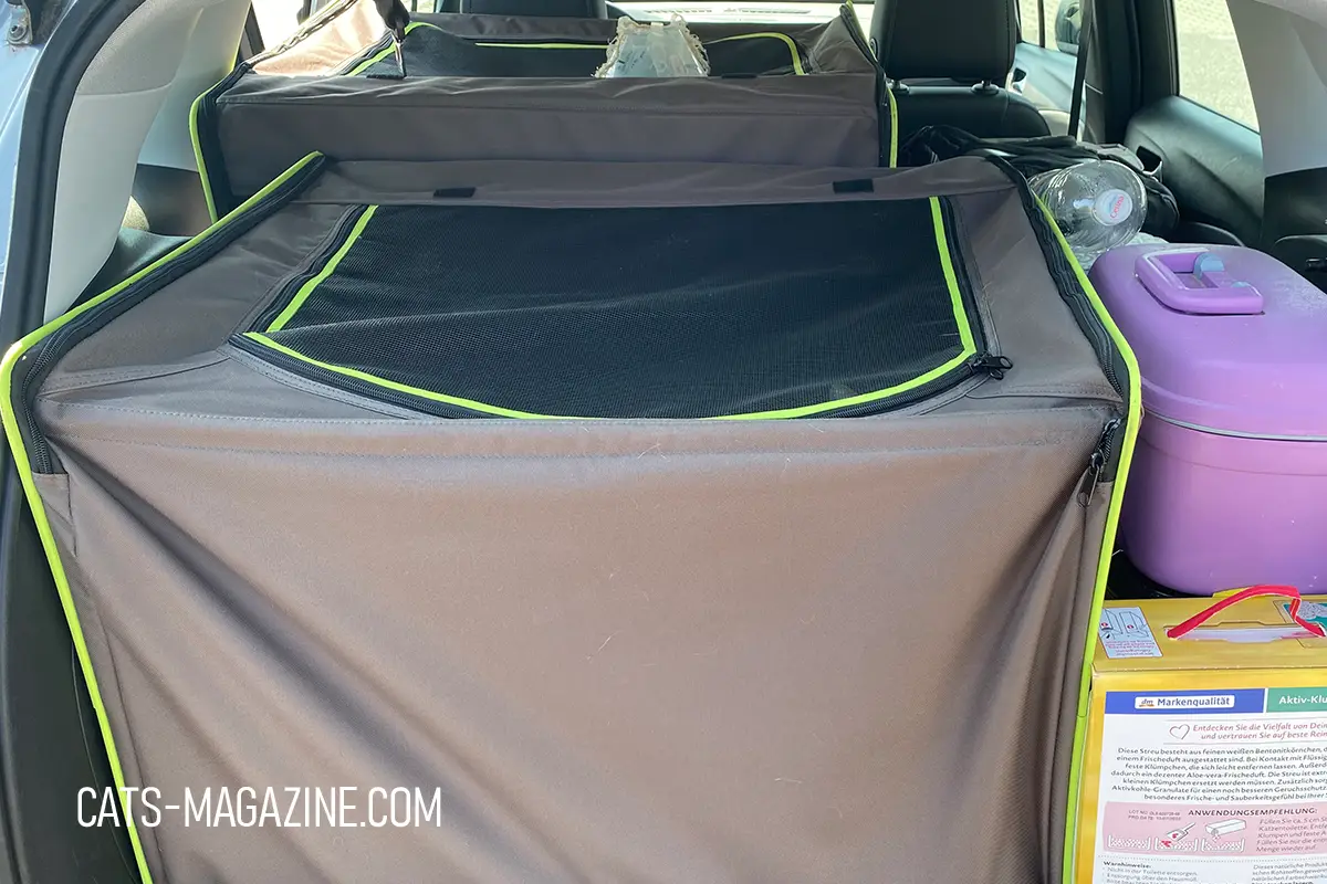 Two connected cat travel crates creating a spacious travel area inside the car